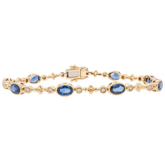 14K Yellow and White Gold Oval Sapphire and Diamond Bezel Tennis Bracelet, view 1