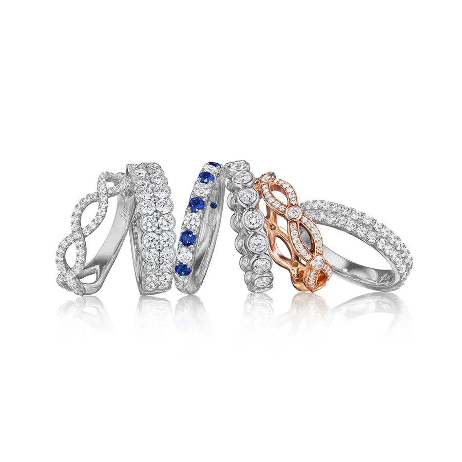 A leaning stack of six diamond and sapphire bands in white and rose gold