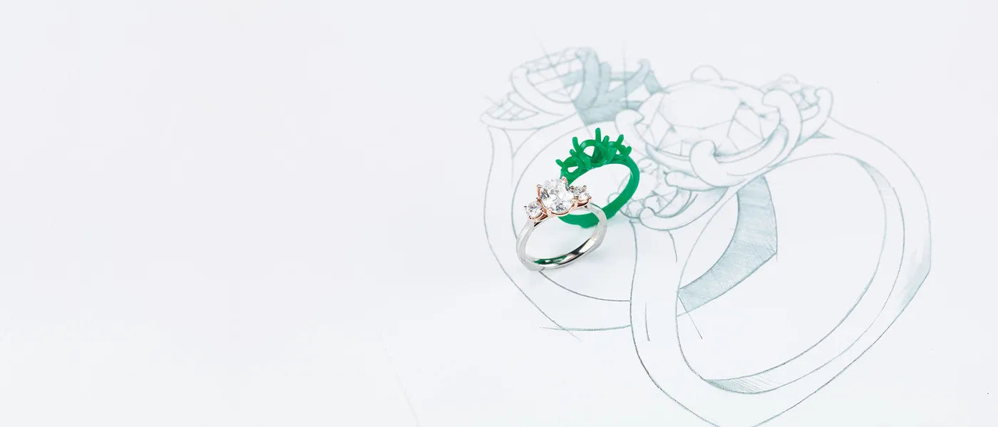 Custom engagement ring design sketches alongside finished pieces