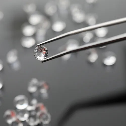 Gemologist examining a diamond with a loupe for appraisal