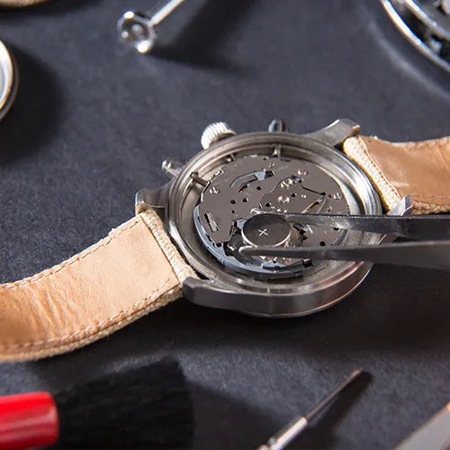 Close-up of a watch battery replacement in progress