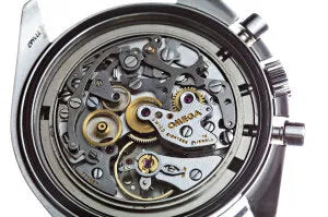 Close detail of a watch under inspection on the bench
